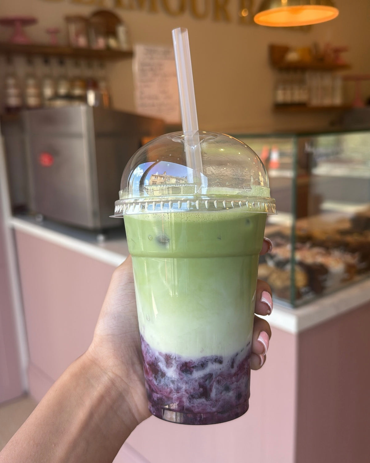 Blueberry Matcha iced drink with a purple fruit layer